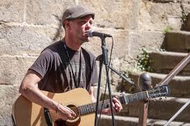 Chanteur avec guitare, dehors.